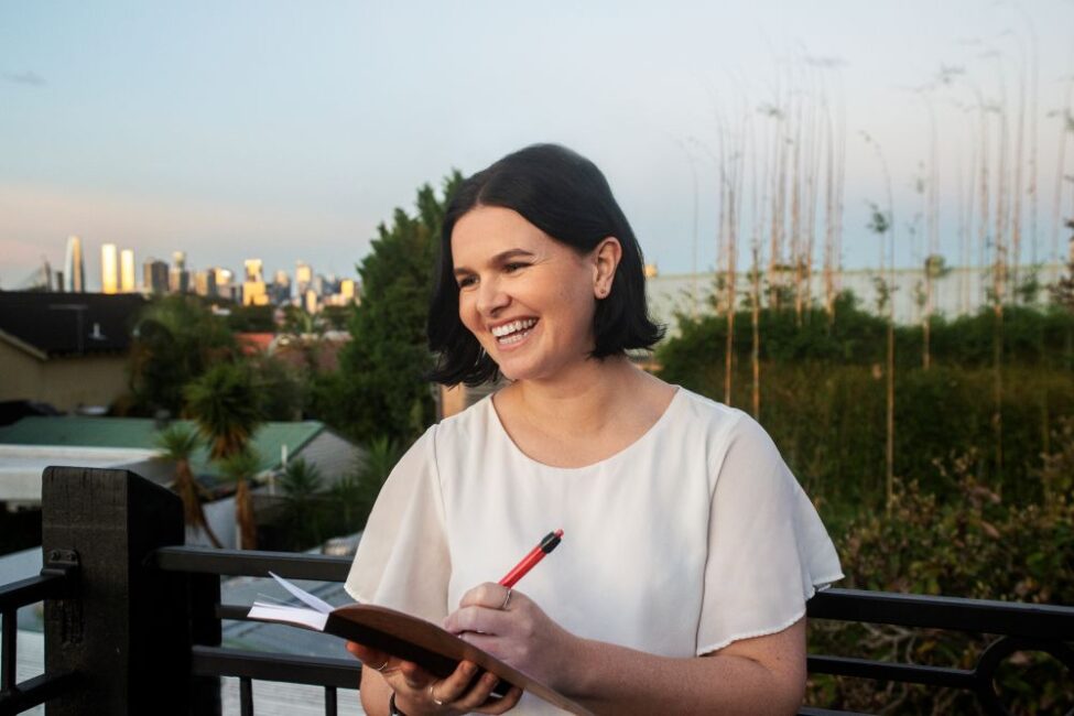 Student, Amy, writing in notepad