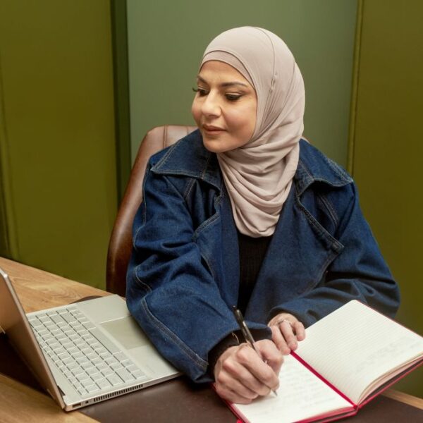 Student Wafa Hawchar writing notes and studying online
