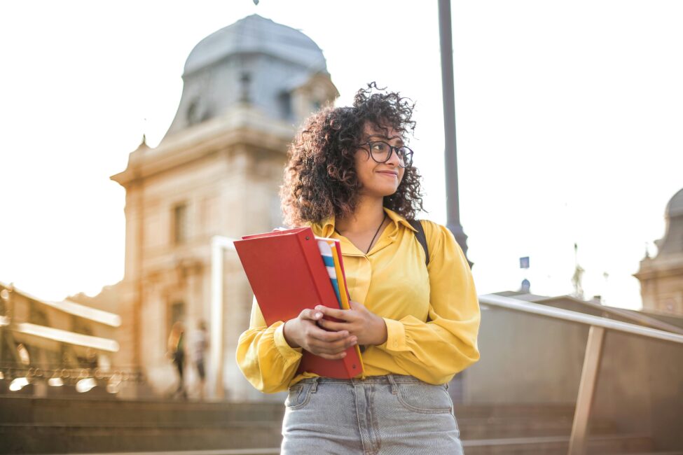 woman standing in front of building smiling